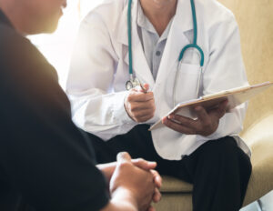 A doctor explaining his cancer misdiagnosis to a patient.