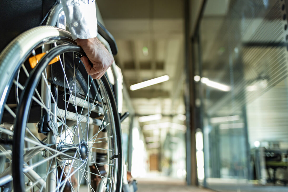 unrecognizable person in a wheelchair after a spinal cord injury.