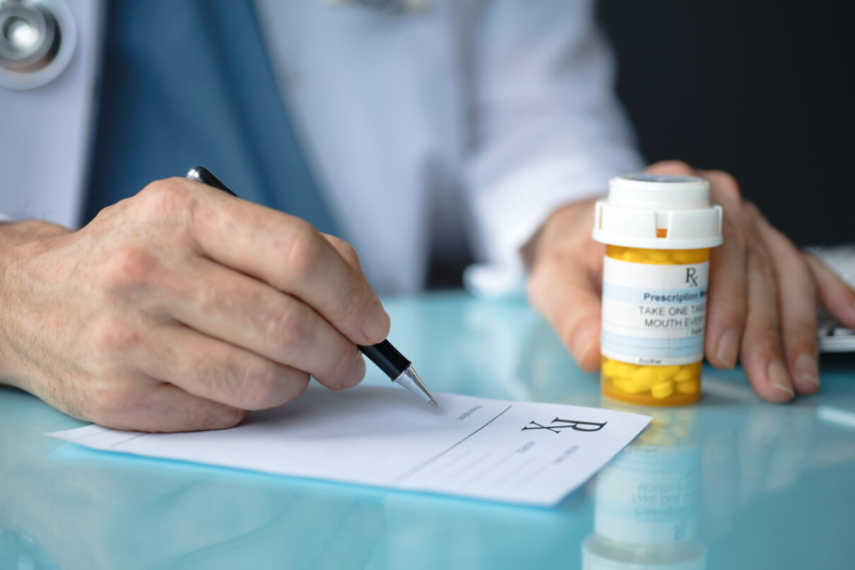 a doctor writing a Prescription Medication order
