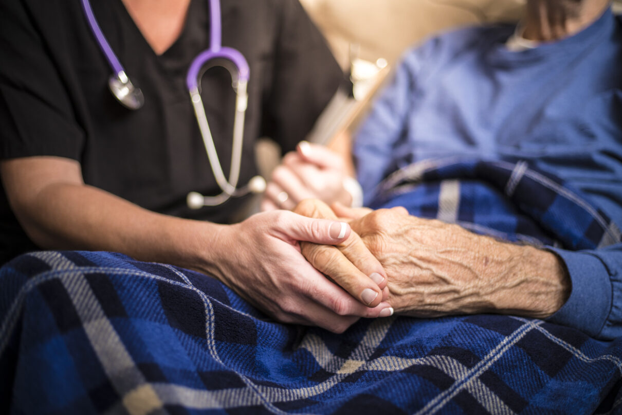 nurse holding a patients hands in one of the community living facilities